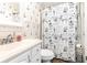 Charming bathroom with lighthouse wallpaper and nautical themed shower curtain at 1310 N Waccamaw Dr. # 211, Garden City Beach, SC 29576
