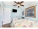 Light blue bedroom features a TV, nautical bedding, and bright window at 1310 N Waccamaw Dr. # 211, Garden City Beach, SC 29576
