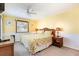 Cozy bedroom features a floral patterned bedspread, bedside tables, and a ceiling fan at 1310 N Waccamaw Dr. # 211, Garden City Beach, SC 29576