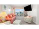 Living room with sliding glass doors opening to a balcony with beach views at 1310 N Waccamaw Dr. # 211, Garden City Beach, SC 29576