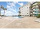 Relaxing pool and lounge area by the beach, perfect for a vacation getaway, complete with palm trees at 1310 N Waccamaw Dr. # 211, Garden City Beach, SC 29576