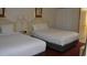 Clean bedroom with two beds, soft lighting and closet at Camelot By The Sea at 2000 Ocean Blvd. N # 216, Myrtle Beach, SC 29588