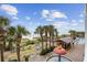 Beach view with palm trees, lounge chairs, and pool at the Camelot By The Sea resort at 2000 Ocean Blvd. N # 216, Myrtle Beach, SC 29588
