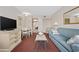 Comfortable living room with a sofa, TV, and dining area at Camelot By The Sea at 2000 Ocean Blvd. N # 216, Myrtle Beach, SC 29588