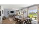 Bright living area with dining set, cozy seating, and sliding door access to the outdoors at 219 Warner Crossing Way, Loris, SC 29569