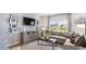 Cozy living room with a large sectional sofa, entertainment center, and scenic views at 219 Warner Crossing Way, Loris, SC 29569
