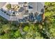 An aerial view of a home with a patio and a long driveway surrounded by trees at 2250 Heritage Loop, Myrtle Beach, SC 29577