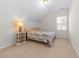 Bright bedroom features neutral walls, a bed with a patterned quilt, and bedside table with lamp at 2250 Heritage Loop, Myrtle Beach, SC 29577