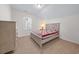 Light-filled bedroom features a queen bed, a dresser, and a window, creating a cozy retreat at 2250 Heritage Loop, Myrtle Beach, SC 29577