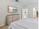 Neutral bedroom with mounted TV, dresser, and open doorway to walk-in closet and bathroom at 2250 Heritage Loop, Myrtle Beach, SC 29577