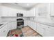 Bright kitchen with white cabinetry, stainless steel appliances, and speckled granite countertops at 2250 Heritage Loop, Myrtle Beach, SC 29577