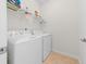 Laundry room with a white washer and dryer and overhead shelving for storage at 2250 Heritage Loop, Myrtle Beach, SC 29577