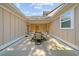 Covered patio with tan siding and a four-chair dining set at 2250 Heritage Loop, Myrtle Beach, SC 29577
