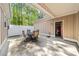 Covered patio with a four-chair dining set situated next to a garage entrance at 2250 Heritage Loop, Myrtle Beach, SC 29577