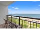 Ocean view from a balcony with chairs, colorful umbrellas, and blue ocean waters at 3000 N Ocean Blvd. # 729, Myrtle Beach, SC 29577
