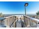 Direct beach access via wooden stairs, providing a convenient path to the sandy shore at 3000 N Ocean Blvd. # 729, Myrtle Beach, SC 29577