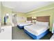 Bright bedroom featuring two beds, fresh linens, and a soothing color palette at 3000 N Ocean Blvd. # 729, Myrtle Beach, SC 29577