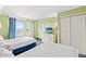 Relaxing bedroom with two comfortable beds, a dresser with a TV, and a view from the balcony at 3000 N Ocean Blvd. # 729, Myrtle Beach, SC 29577
