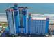 A blue and white ocean front resort with balconies, a pool, and a sandy beach at 3000 N Ocean Blvd. # 729, Myrtle Beach, SC 29577