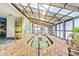 Relaxing indoor hot tub with brick trim, murals, translucent roof, and lounge seating nearby at 3000 N Ocean Blvd. # 729, Myrtle Beach, SC 29577