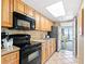 A kitchen with wooden cabinets, stainless steel appliances, and a partial ocean view at 3000 N Ocean Blvd. # 729, Myrtle Beach, SC 29577
