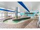 Indoor lazy river with tiled accents, murals, a translucent roof, and lounge seating nearby at 3000 N Ocean Blvd. # 729, Myrtle Beach, SC 29577