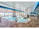 Spacious indoor pool and hot tub area with brick trim, murals, and a translucent roof at 3000 N Ocean Blvd. # 729, Myrtle Beach, SC 29577
