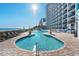 Outdoor pool and sundeck with lounge chairs overlooking the ocean and nearby condos at 3000 N Ocean Blvd. # 729, Myrtle Beach, SC 29577