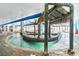 Playful indoor water area with a hut, palm trees, murals, and a translucent roof at 3000 N Ocean Blvd. # 729, Myrtle Beach, SC 29577