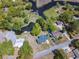 An aerial view showcases the home, with its in-ground pool and surrounding lush green landscaping and water feature at 391 Waterford Dr., Georgetown, SC 29440