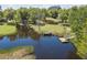 Aerial view showcases a dark pond with docks, trees, and some grass in this beautiful rural setting at 391 Waterford Dr., Georgetown, SC 29440