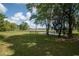 Lush backyard featuring mature trees and a serene pond, offering a private outdoor oasis at 391 Waterford Dr., Georgetown, SC 29440