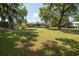 Expansive backyard featuring mature trees, lush lawn, and access to a screened in porch at 391 Waterford Dr., Georgetown, SC 29440