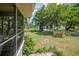 Scenic backyard view from screened porch featuring pond, lush greenery, and peaceful surroundings at 391 Waterford Dr., Georgetown, SC 29440