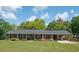 Charming brick home featuring a manicured lawn and a convenient covered carport at 391 Waterford Dr., Georgetown, SC 29440