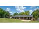 Brick home featuring a covered carport and lush greenery, providing a comfortable living space at 391 Waterford Dr., Georgetown, SC 29440