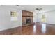Relaxing living room with brick fireplace and hardwood-style floors at 391 Waterford Dr., Georgetown, SC 29440