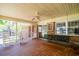 Relaxing screened porch featuring rocking chairs and a porch swing with classic brick exterior at 391 Waterford Dr., Georgetown, SC 29440