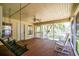 Inviting screened porch with a porch swing and rocking chairs offers serene views of the pond at 391 Waterford Dr., Georgetown, SC 29440