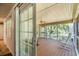Inviting screened porch with wood floors, fan, and views of the lush backyard and serene pond at 391 Waterford Dr., Georgetown, SC 29440