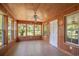 Cozy sunroom with wood-paneled walls, tile floor, and many windows for natural light at 391 Waterford Dr., Georgetown, SC 29440