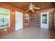 Bright sunroom featuring tile flooring, white door, and brick accent wall at 391 Waterford Dr., Georgetown, SC 29440