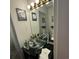 Bathroom featuring a glass bowl sink, black vanity, decorative lighting, and neutral decor at 4701 N Kings Hwy. # 19, Myrtle Beach, SC 29579