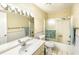 Well-lit bathroom featuring a single sink vanity, framed mirror, and a shower-tub combination at 4701 N Kings Hwy. # 19, Myrtle Beach, SC 29579