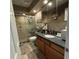 Modern bathroom with glass-enclosed shower, granite vanity, and wood cabinets at 4701 N Kings Hwy. # 19, Myrtle Beach, SC 29579
