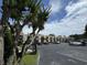 Overview of the townhome community with ample parking, mature trees, and well-maintained exteriors for a pleasant living environment at 4701 N Kings Hwy. # 19, Myrtle Beach, SC 29579