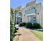 Multi-Gathering unit with blue siding and lush landscaping at 4701 N Kings Hwy. # 19, Myrtle Beach, SC 29579