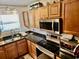 A well-lit kitchen features wooden cabinets, modern appliances, and black countertops at 4701 N Kings Hwy. # 19, Myrtle Beach, SC 29579