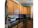 Updated kitchen with stainless steel appliances, dark countertops, and well-lit cabinetry for a modern cooking experience at 4701 N Kings Hwy. # 19, Myrtle Beach, SC 29579