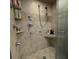 Tiled shower equipped with multiple shower heads and tiled product shelves at 4701 N Kings Hwy. # 19, Myrtle Beach, SC 29579
